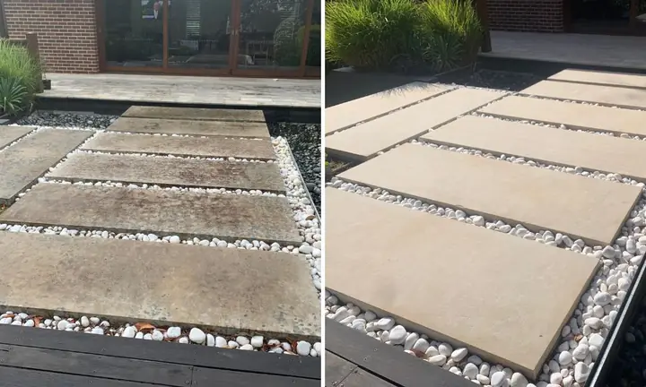 Large sandstone stepping pavers set in white pebbles, before and after pressure washing: dark and stained on the left, clean on the right.